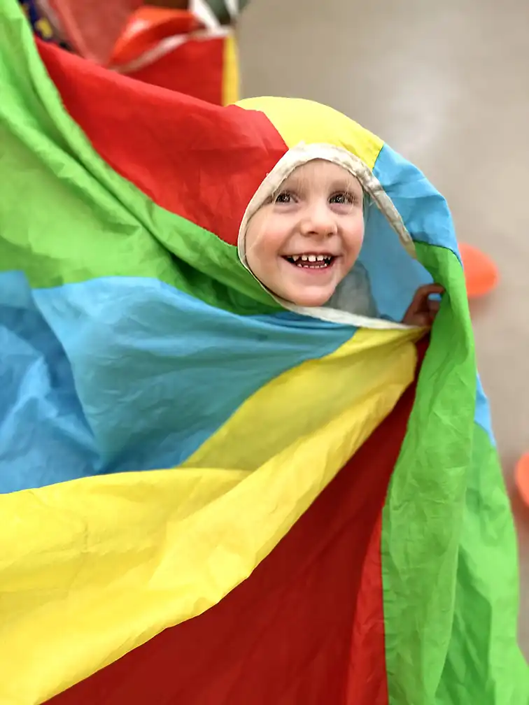 Kids playing in a parachute